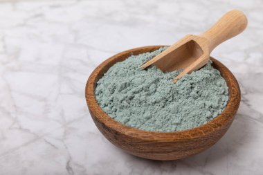 Blue Spirulina algae powder on white marble background. Diet and detox concept.Natural vegan superfood. Food supplement. Copy space. Place for text.