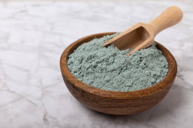 Blue Spirulina algae powder on white marble background. Diet and detox concept.Natural vegan superfood. Food supplement. Copy space. Place for text.