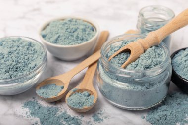 Blue Spirulina algae powder on white marble background. Diet and detox concept.Natural vegan superfood. Food supplement. Copy space. Place for text.