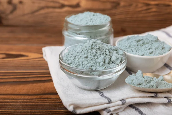 Blue Spirulina algae powder on brown texture background. Diet and detox concept.Natural vegan superfood. Food supplement. Copy space. Place for text.