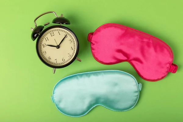 Sleeping mask on a green background. FLAT LAY. Concept of rest and quality of sleep. good night, insomnia, relaxation.
