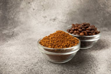 Instant coffee and coffee beans on a black stone background. Aromatic coffee drink. Place for text. Space for copy text