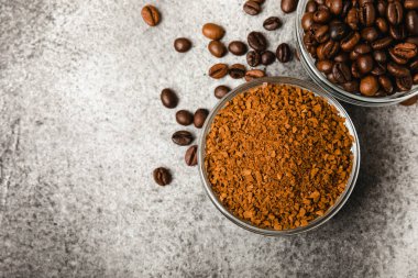 Instant coffee and coffee beans on a black stone background. Aromatic coffee drink. Place for text. Space for copy text