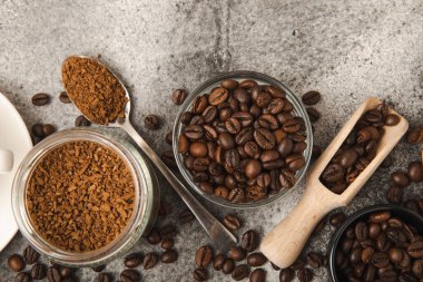 Instant coffee and coffee beans on a black stone background. Aromatic coffee drink. Place for text. Space for copy text