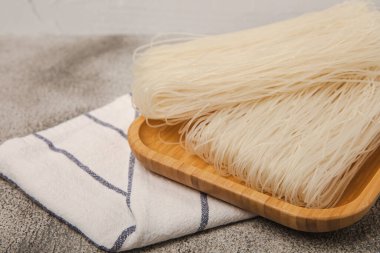 Rice noodles with rice flour on a black textured background.Close-up. Place for text. Copy space.