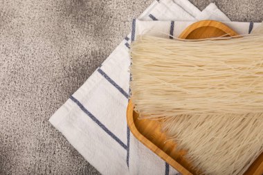 Rice noodles with rice flour on a black textured background.Close-up. Place for text. Copy space.
