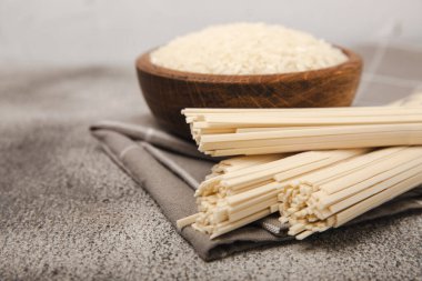 Rice noodles.Rice and noodles with rice flour in a wooden plate on a black background.Close-up. Place for text. Copy space.