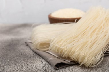 Rice noodles.Rice and noodles with rice flour in a wooden plate on a black background.Close-up. Place for text. Copy space.