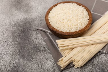 Rice noodles.Rice and noodles with rice flour in a wooden plate on a black background.Close-up. Place for text. Copy space.