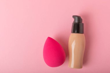 Colorful bright beauty sponges on a pink background. Beauty concept. Cosmetic tool for applying and blending and applying foundation, concealer. Copy space for text.