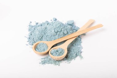 Blue spirulina powder in spoon isolated on white background. Natural vegan superfood. food supplement.