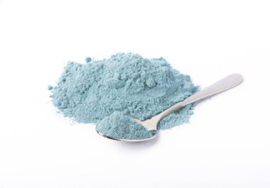Blue spirulina powder in spoon isolated on white background. Natural vegan superfood. food supplement.