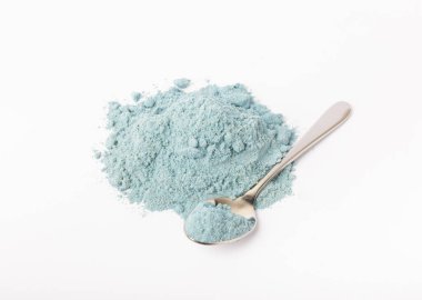 Blue spirulina powder in spoon isolated on white background. Natural vegan superfood. food supplement.
