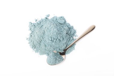 Blue spirulina powder in spoon isolated on white background. Natural vegan superfood. food supplement.