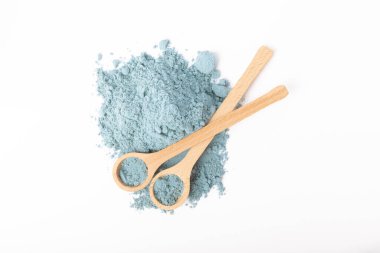 Blue spirulina powder in spoon isolated on white background. Natural vegan superfood. food supplement.