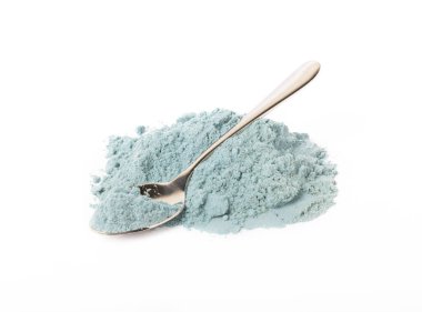 Blue spirulina powder in spoon isolated on white background. Natural vegan superfood. food supplement.