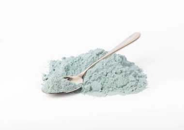 Blue spirulina powder in spoon isolated on white background. Natural vegan superfood. food supplement.