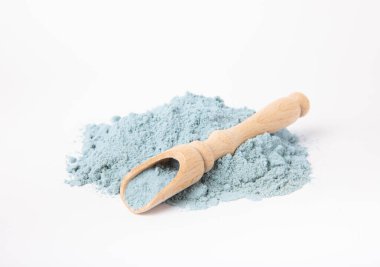 Blue spirulina powder in spoon isolated on white background. Natural vegan superfood. food supplement.