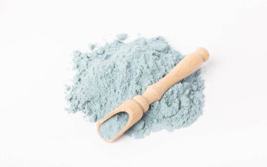 Blue spirulina powder in spoon isolated on white background. Natural vegan superfood. food supplement.