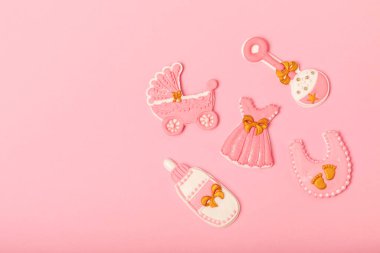 Set of delicious baby shower cookies on a pink textured background. Gender cookies.Baby shower party. Close-up. Flat lay. Place for text.