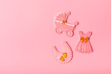 Set of delicious baby shower cookies on a pink textured background. Gender cookies.Baby shower party. Close-up. Flat lay. Place for text.
