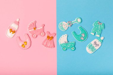 Boy or girl.A set of delicious baby shower cookies on a colorful background. Gender cookies.Baby shower party. Close-up. Flat lay. Place for text.