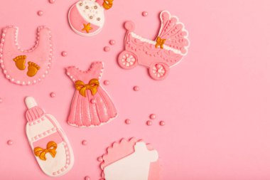 Set of delicious baby shower cookies on a pink textured background. Gender cookies.Baby shower party. Close-up. Flat lay. Place for text.