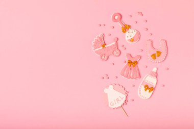 Set of delicious baby shower cookies on a pink textured background. Gender cookies.Baby shower party. Close-up. Flat lay. Place for text.