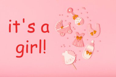 Set of delicious baby shower cookies on a pink textured background. Gender cookies.Baby shower party. Close-up. Flat lay. Place for text.