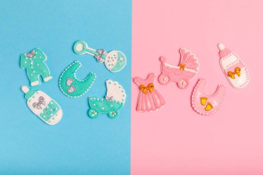 Boy or girl.A set of delicious baby shower cookies on a colorful background. Gender cookies.Baby shower party. Close-up. Flat lay. Place for text.