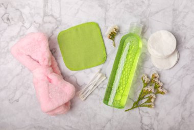 Micellar cleansing water and pads for removing cosmetics and cleansing the skin of sebium on a white marble background. Copy text. Place to copy. FLETLEY. Beauty concept.