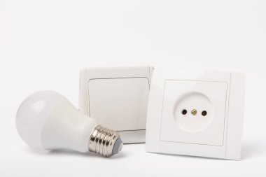 LED lamp, Wall light switch and socket isolated on white background. MOKAP.Electric concept.