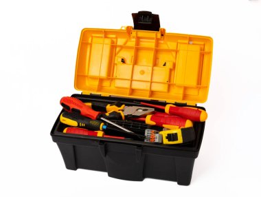 Toolbox isolated on white background.Box with electrician's tools. Multimeter, construction tape, electrical tape, screwdrivers, pliers and an automatic insulation stripper.