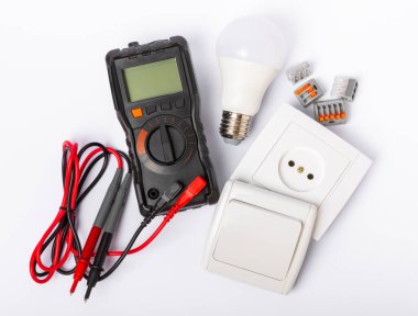 Electrician tools isolated on white background.Electrician tools set. Multimeter, construction tape, electrical tape, screwdrivers, pliers, LED lamp, socket, switch and automatic insulation stripper.