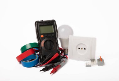Electrician tools isolated on white background.Electrician tools set. Multimeter, construction tape, electrical tape, screwdrivers, pliers, LED lamp, socket, switch and automatic insulation stripper.