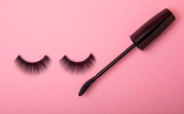 Composition with mascara and false eyelashes on a pink background. Flat lay composition. Beauty industry concept.Place for text. Copy Spys.