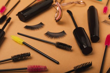Composition with eyelash curler, mascara, eyelash growth oil and false eyelashes on colored background. Flat lay composition. Beauty industry concept.Place for text. Copy Spys.