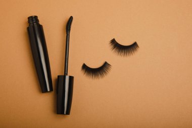 Composition with mascara and eyelash brushes, false eyelashes on a textured background. Flat lay composition. Beauty industry concept.Place for text. Copy Spys.