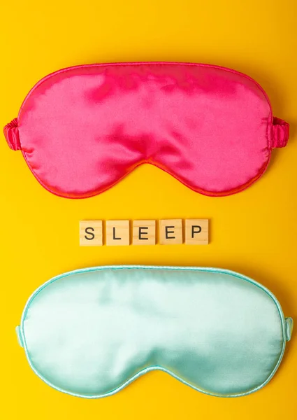 Sleep mask on a yellow background. Sweet dreams concept. The concept of rest, sleep quality, good night, insomnia and relaxation. Flat lay, mockup. view from above