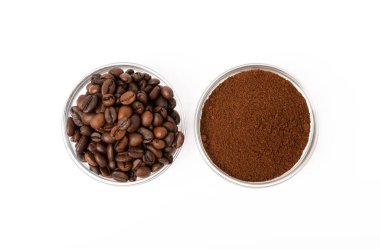Bowl of ground coffee and beans isolated on a white background.
