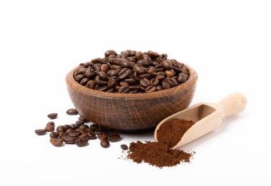 Bowl of ground coffee and beans isolated on white background. Coffee in wooden spoons.