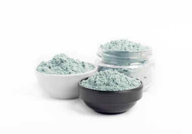 Blue spirulina powder in bowls isolated on white background. Natural vegan superfood. Food supplement. Phycocyanin extract.