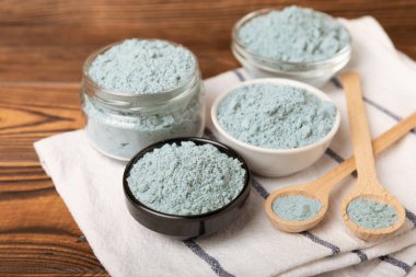 Blue spirulina powder in bowls on a brown table. Natural vegan superfood. Food supplement. Phycocyanin extract. Healthly food. Place for text. Copy space.