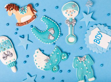 Baby shower cookies on a blue background. Delicious cookies for a baby party. Baby shower party concept. Flat lay. View from above. candy bar. Gender party.