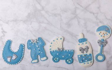 Baby shower cookies on a white marble background. Delicious cookies for a baby party. Baby shower party concept. Flat lay. View from above. candy bar