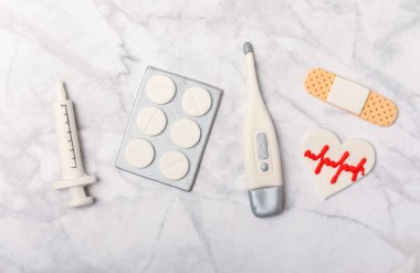 Doctor's Day greeting card with gingerbread on a marble background. Cookies for the day of the doctor in the form of medical equipment. Concept of healthcare and medicine.