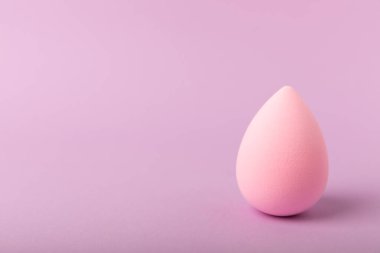 Beauty blender. Colorful beauty sponges on a lilac background. Cosmetic tool for applying foundation, concealer. Place for text. Place to copy.