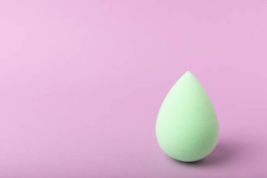 Beauty blender. Colorful beauty sponges on a lilac background. Cosmetic tool for applying foundation, concealer. Place for text. Place to copy.