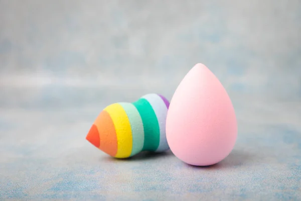 Beauty blender. Colorful beauty sponges on a marble background. Cosmetic tool for applying foundation, concealer. Place for text. Place to copy.
