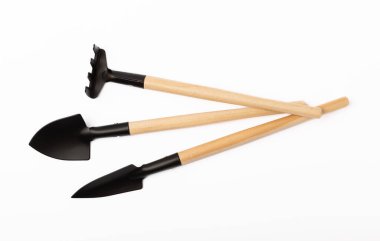Garden shovel and fork, garden rake isolated on white background. Gardening Tools.